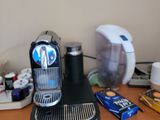 a coffee maker on a dresser in a room