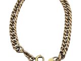 a close up of a bracelet with a heart on it