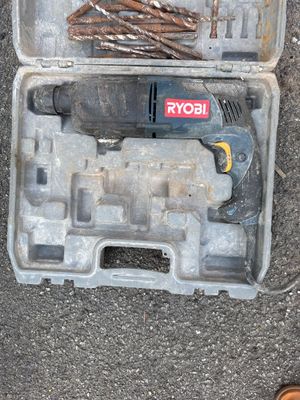 a tool in a case on the ground next to a pair of shoes