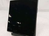 a black laptop sitting on a stand on a white surface