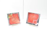 two pieces of art that are sitting on a table