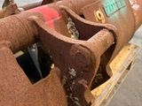 a rusted pipe sitting on a pallet in a warehouse