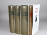 three books sitting on top of each other in front of a white box