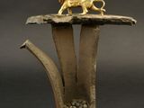 a gold lion statue sitting on top of a wooden table