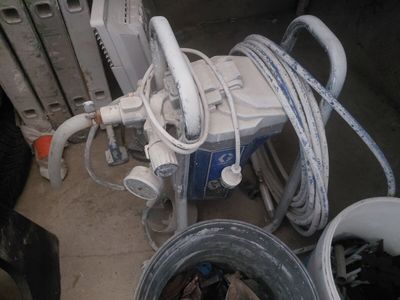several buckets of water and hoses sitting next to a radiator