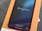 an iphone xr with a box on a table with a price tag on it