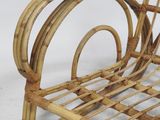 a wicker chaise that is sitting on a white surface