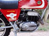 a red and white motorcycle parked on the side of the road