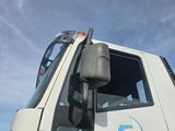 a white truck with a blue logo on the side of it