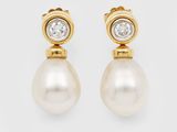 a pair of pearl and diamond earrings