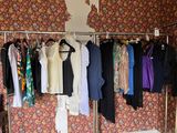 a lot of clothes hanging on a rack in a room