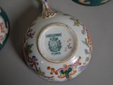 a close up of a vase with a lid on a table