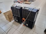 two air conditioners sitting on the floor in a store