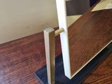 a wooden table with a glass of wine on top of it