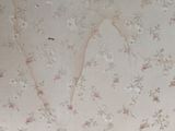 a cat that is laying on the floor in front of a wallpaper