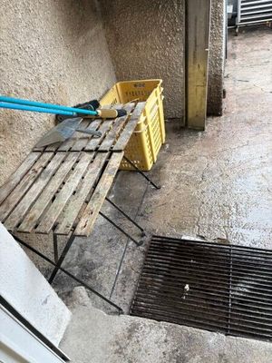 a wooden bench sitting on the side of a building