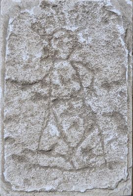 relief of an angel on a stone block in the shape of a cross