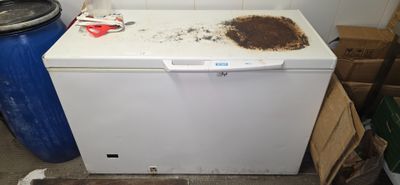 a dirty dishwasher sitting in a dirty kitchen