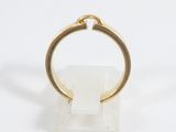 an image of a gold ring sitting on top of a white marble block