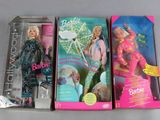 three barbie dolls are sitting in a box on a table