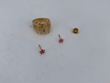 the gold ring is sitting on top of a white plate