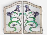 a close up of a stained glass window with flowers on it