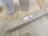 two bottles of perfume sitting on a table next to each other