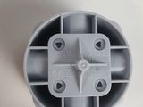 an overhead view of a gray plastic object on a white surface