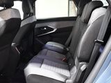 the back seats of a blue car with black trims and gray seats