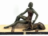 statue of a woman and a dog sitting on a wooden platform