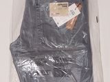 a pair of jeans in a plastic bag on a table
