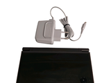 a black tablet with a charger on top of it