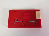 a close up of a red nintendo game console on a white surface