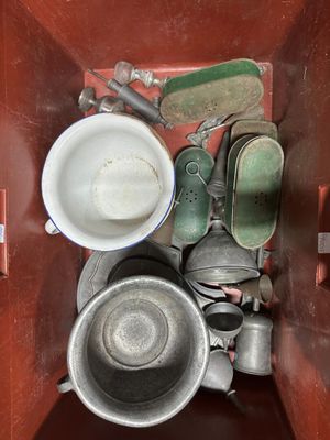 a metal container filled with a lot of dirty dishes