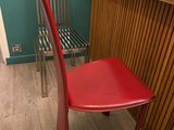 une chaise rouge placée devant un bureau dans une pièce