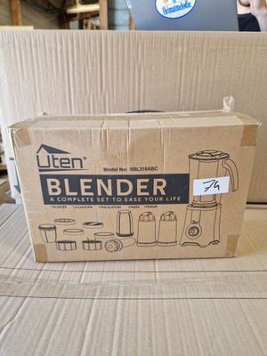 cardboard box sitting on top of a cardboard table with a blender in it
