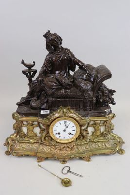 a clock that is sitting on a table next to a pair of scissors