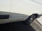 a white van that is parked on the side of the road
