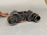 a pair of binoculars sitting on the ground next to each other
