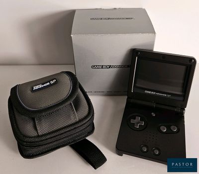 a small black gameboy sitting next to a black case