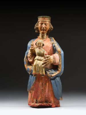an old statue of a man holding a baby in his arms