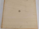 a close up of a piece of wood with a hole in it
