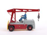 a toy truck with a man sitting in the back of it