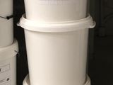 several buckets of food are stacked on top of each other in a garage