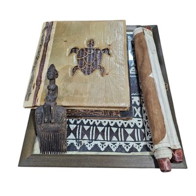 a wooden box with a book, a brush, and a piece of paper