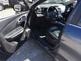 a car door open with the driver ' s seat down