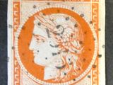 an orange and white stamp with a woman ' s head on it