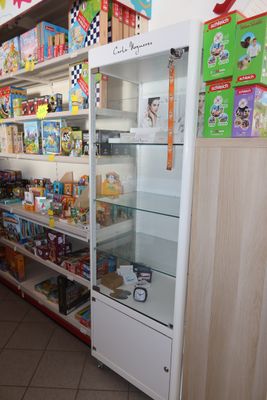 a refrigerator in the middle of a store filled with food