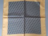 a close up of a blue and yellow handkerchief on a table