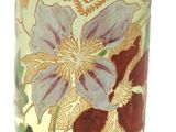 a vase with a floral design on it on a table